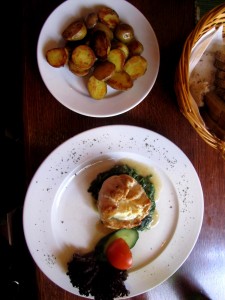 Chicken stuffed with cheese served with spinach and backed potatoes