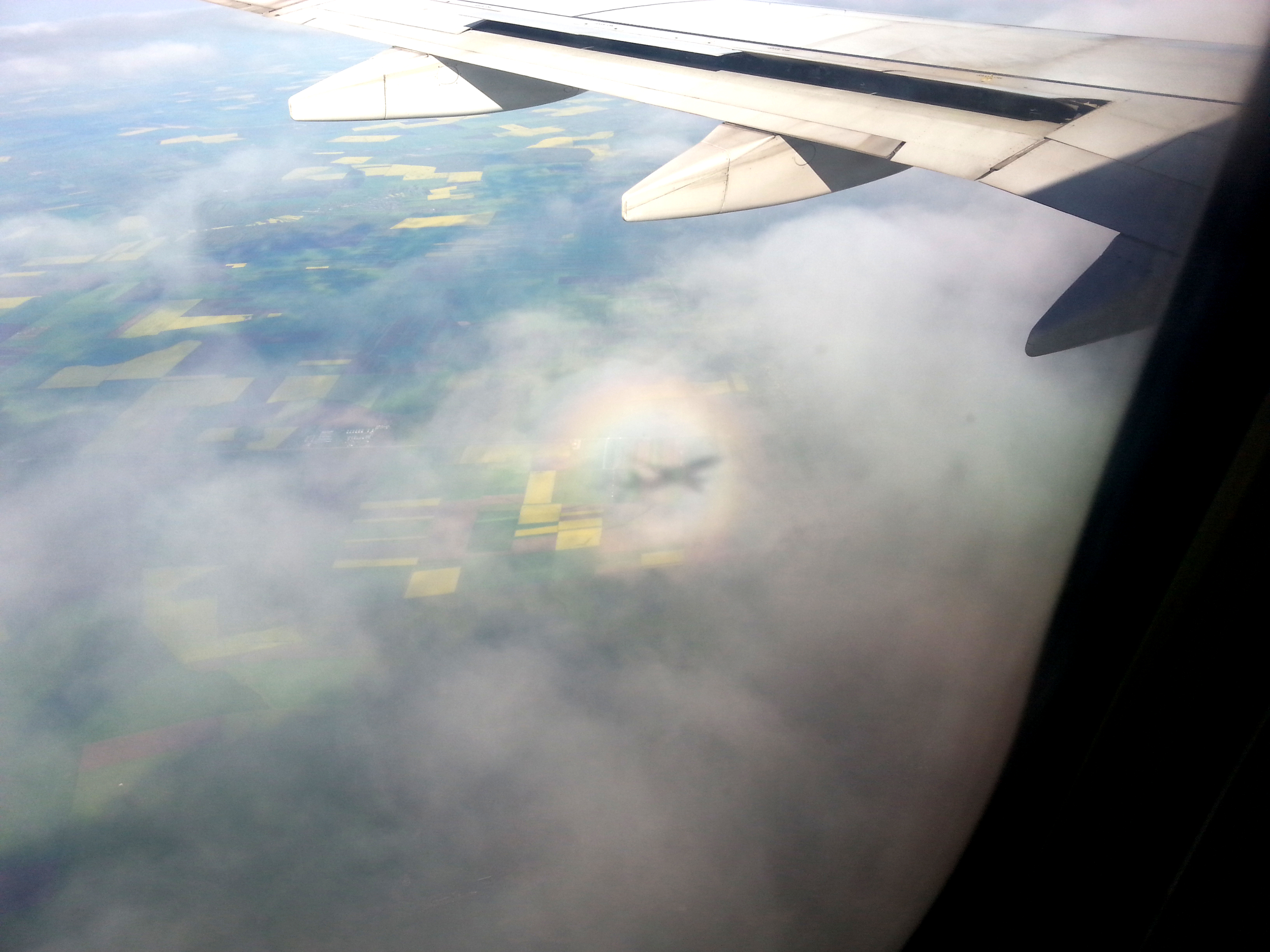 Airplane seen through the clouds from an airplane