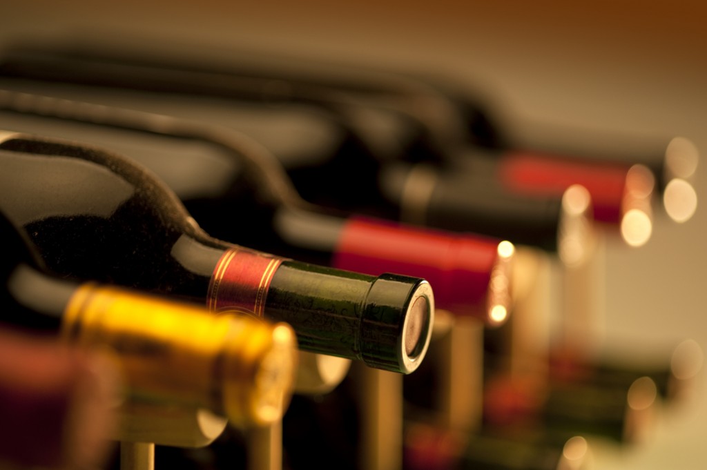 Red wine bottles stacked on wooden racks Red wine bottles stacked on wooden racks 